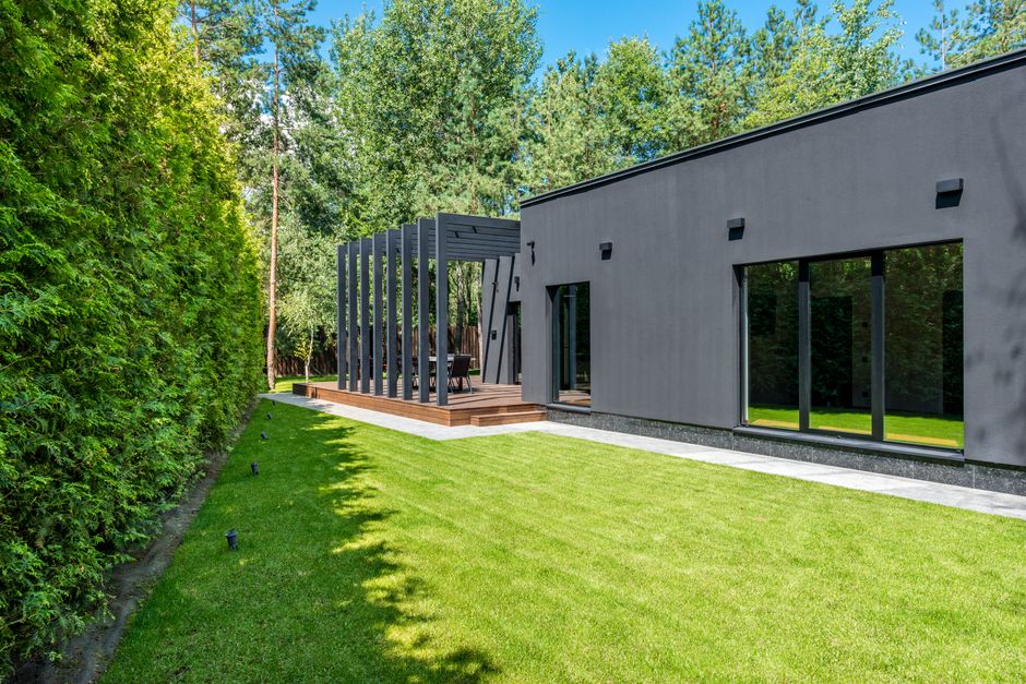 Beautiful modern suburban home with a well-manicured lawn on a bright, sunny day, representing an ideal Northshore propert...